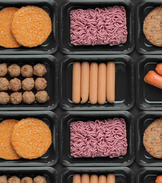 pattern of green trays with vegetarian meat substitute products, plant based mock meat