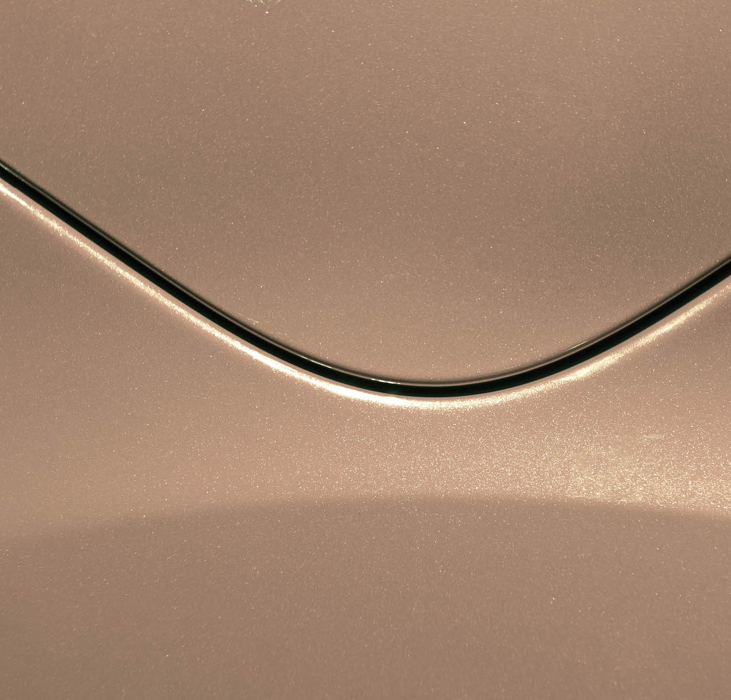 Smooth curves of bright yellow metal car body. Abstract - steel post envelope.